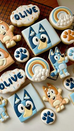 decorated cookies are arranged on a cooling rack