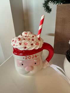 a cup with a frosted drink in it and a candy cane sticking out of the top