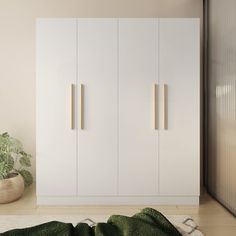 a white wardrobe with two doors and three drawers next to a potted plant on the floor