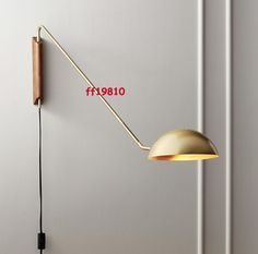 a wall lamp with a cord attached to it next to a light fixture on the wall