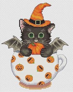 a black cat sitting on top of a cup with bats and pumpkins around it