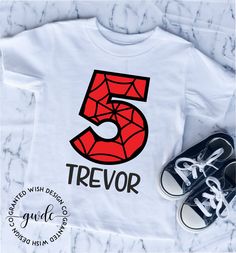 a t - shirt with the number five on it and some sneakers next to it