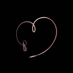 a heart with a hook in the middle and a string hanging from it's side