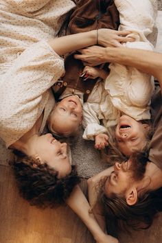 a group of people laying on top of a wooden floor