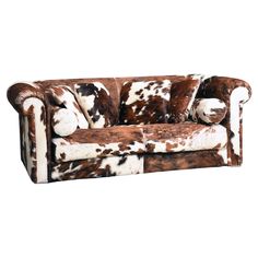 a brown and white couch with pillows on it