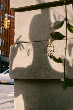 the shadow of a person's head on a wall next to a traffic light