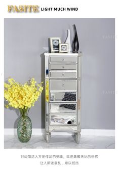 a vase with yellow flowers sitting on top of a table next to a white wall