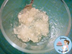 ice cubes in a glass bowl with a wooden spoon