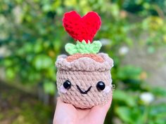 a small crocheted cupcake with a red heart on it's top