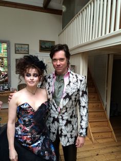 a man and woman dressed up in formal wear