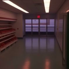 an empty room with shelves and red lights