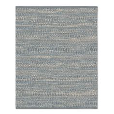 a blue and white rug with wavy lines on the bottom, in an area that looks like it has been made out of wool