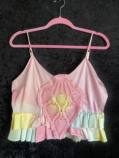 Vintage slip cropped top Adjustable shoulder straps  Hand dyed pink  Tattered hand dyed remnants around the base. Colors of pinks, greens and yellows  One vintage leaf shaped doily placed on the front chest area. Hand dyed pink with yellow center  Wear it by itself or layer it up. 😊 Women's size XL  Please ask for measurements if interested  Thank you Pink Hand Dyed Cotton Top, Pink Cropped Cotton Crop Top, Pink Cotton Crop Top Tank, Vintage Pink Tank Top For Summer, Pink Hand Dyed Tops For Spring, Spring Hand Dyed Pink Tops, Bohemian Cotton Crop Top With Lace Trim, Sleeveless Pink Crop Top For Festival, Pink Vintage Patchwork Top