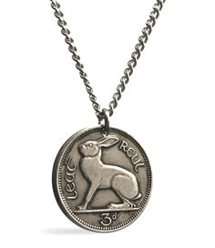 a coin necklace with a dog on it