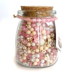 a glass jar filled with lots of beads