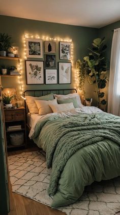 a bedroom with lights on the wall above the bed and green comforter in front of it