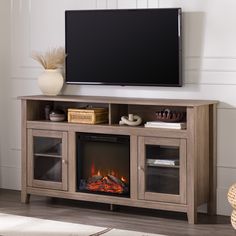 an entertainment center with a fireplace in the middle and a flat screen tv above it