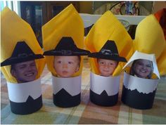 four children's hats made out of paper cups with faces on them, sitting on a table