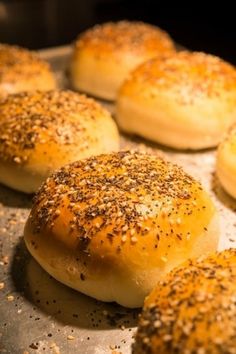 bread rolls with sesame seeds and seasoning sprinkled on them