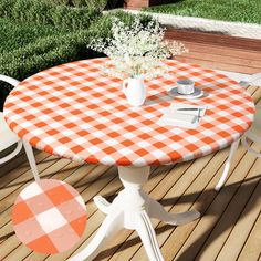 an orange and white checkered tablecloth on a wooden deck