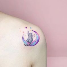 a cat sitting on the moon with stars around it's neck and back tattoo