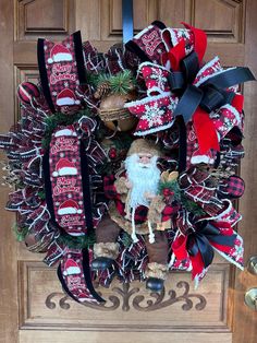 a christmas wreath with santa claus and bells on it, hanging from the front door