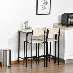 three stools sit in front of a small table with a toaster oven on it