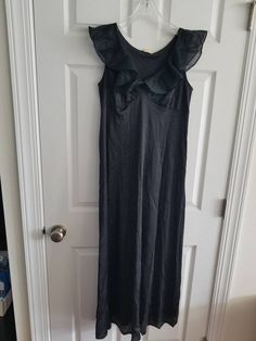 This is a vintage, Gilead night gown. It is sleeveless and has a ruffled portion. It is nylon, made in the usa and floor length. There are some flaws in the material as you can see in the images. The price reflects this. All sales are final. The measurements are as follows: (measurements taken flat and unstretched) Nightgown: Armpit to Armpit: 18 inches Waist: 17.5 inches Hips: 26 inches Length from top of shoulder to middle of hem: 52.5 inches This is a very elegant piece. It is timeless and cl Black Sleeveless Maxi Dress For Loungewear, Sleeveless Cotton Maxi Dress For Evening, Sleeveless Ruffled Dress For Loungewear, Sleeveless Ruffled Loungewear Dress, Sleeveless Summer Evening Nightgown, Vintage Fitted Ruffle Nightgown, Vintage Fitted Nightgown With Ruffles, Fitted Vintage Nightgown With Ruffles, Party Sleeveless Nightgown With Lace Trim