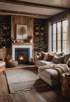 a living room filled with furniture and a fire place next to a window covered in blankets