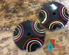 Soft lightweight earrings has been hand crafted and painted from Totumo bark . Totumo is a bark comes from Colombian fruit tree however is softer than wood. you can choose from 4 different patterns/colours: 1. colours: black, white, green, yellow 2. black, teal, white 3. black, red, yellow, pink 4. black, pink, yellow, white Dimensions: width 6 cm (2'') length with hooks: 6 cm (2.5'') Ear Weights, Fruit Tree, Boho Geometric, Lightweight Earrings, Wooden Earrings, Light Weight Earrings, Fabric Gifts, Alpaca Wool, Orange Brown