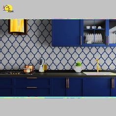 a kitchen with blue cabinets and white tile backsplash, gold trimmings