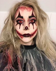 a woman with long blonde hair and makeup is dressed up as a creepy clown for halloween