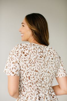 Feel effortlessly beautiful all day long in a peplum top this fall! The 'Paula' top has a smocked bodice, flutter sleeves, and comes in a dainty leaf print. Pair it with a denim skirt for a casual look, or a brown corduroy skirt for a simple elevated fit! 100% Polyester Hand Wash Cold Hang or Lay Flat to Dry Cool Iron If Needed Do Not Bleach Model Height 5'9" | Wearing Size Small Wearing the 'Paula' Smocked Peplum Top with the 'Autumn' Corduroy Skirt in Chocolate. Please carefully measure a simi Flowy Smocked Top With Ruched Short Sleeves, Flowy Ruched Smocked Top With Short Sleeves, Feminine Smocked Top With Smocked Back For Fall, Feminine Fall Smocked Top With Smocked Back, Short Sleeve Smocked Top With Smocked Cuffs For Brunch, Fall Feminine Smocked Top With Smocked Back, Flowy Smocked Top With Flutter Sleeves, Beige Smocked Bodice Top For Day Out, Flowy Smocked Bodice Top With Flutter Sleeves