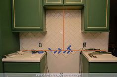 a kitchen with green cabinets and white counter tops is being remodeled in preparation for remodeling