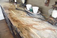 a marble counter top with candles on it