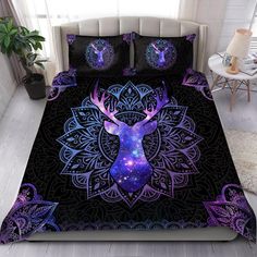 a bed covered in purple and blue sheets with a deer's head on it