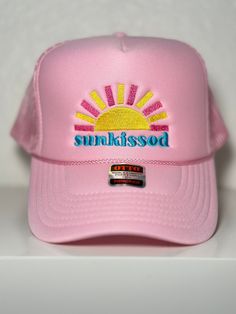 Embroidered "Sunkissed" Pink Trucker Hat Trendy Trucker Hat Visor For Vacation, Trendy Summer Baseball Cap With Flat Brim, Beach Trucker Hat With Embroidered Logo And Curved Brim, Trucker Hat With Embroidered Logo For Beach, Trendy Trucker Hat With Uv Protection Snapback, Embroidered Snapback Hat For Summer, Trendy Snapback Trucker Hat With Uv Protection, Adjustable Beach Baseball Cap With Embroidered Logo, Pink Visor For Summer Beach