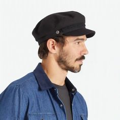 On a white background is a model wearing a black fiddler cap with a cord detail. Black Cotton Flat Cap, Black Cotton Baseball Cap With Short Brim, Black Cotton Baseball Cap, Brixton Fiddler Cap, Fiddler Cap, Logo Pin, Pin Logo, Cap Men, The Shade