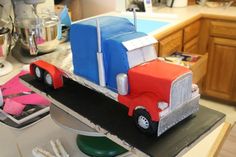 a cake made to look like a semi - truck is on the counter in a kitchen