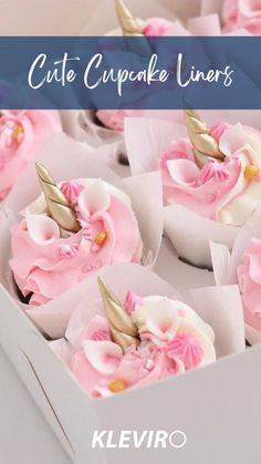 cupcake liners with pink frosting and gold horn decorations in a white box