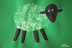 a sheep made out of plastic bottles on a green background