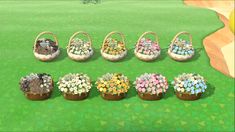 a bunch of baskets filled with flowers on top of a green field