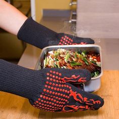 a person in black gloves is holding a tray with food