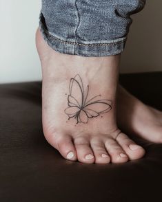 a small butterfly tattoo on the foot