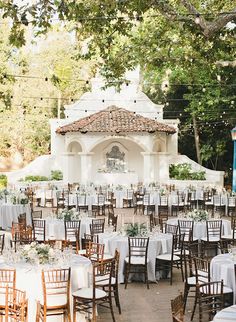 an outdoor wedding venue with tables and chairs