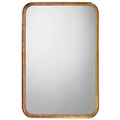 a gold framed mirror sitting on top of a white wall