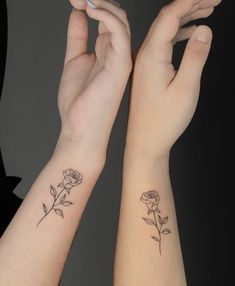 two hands with tattoos on their arms and one has a rose tattoo on the wrist