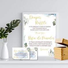 the wedding stationery is displayed next to a vase with flowers and greenery on it