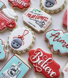 many decorated cookies are displayed on a table