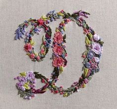 the letters o and o are made out of flowers on a piece of linen fabric